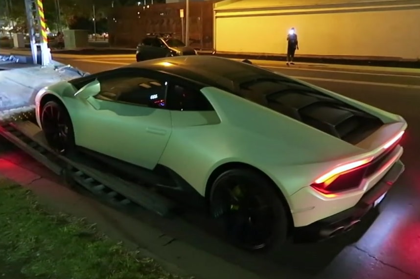 A car being unloaded from a truck