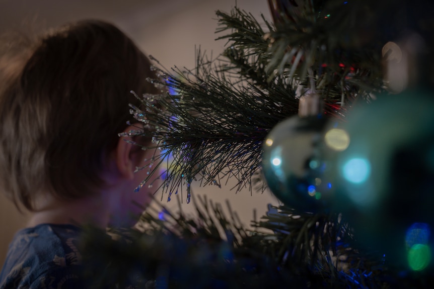 Boy near Christmas tree