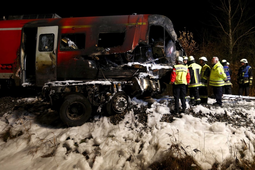 Firefighters at the scene of a train crash in Bavaria, Germany