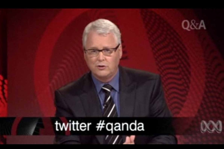 Q and A host Tony Jones appears at the start of the program with Twitter hashtag details on screen. (ABC TV)