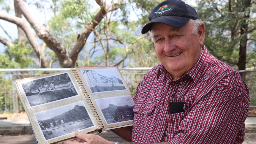 A man holds a photo album