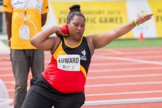 A Papua New Guinean shot putter prepares to throw the shot put during competition.