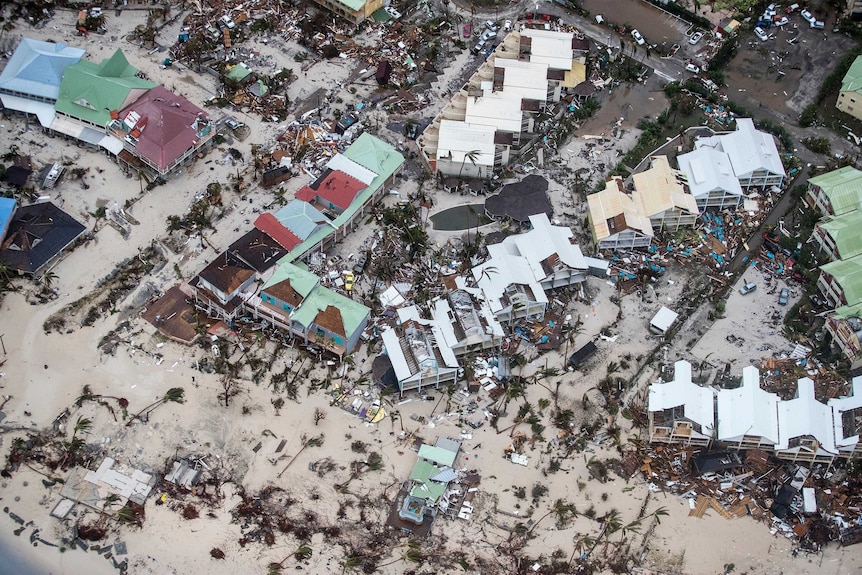 Aerial shot shows several homes levelled on saint martin by the beach