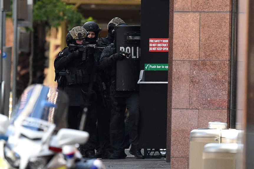 Police with weapons raised on Phillip Street, Sydney