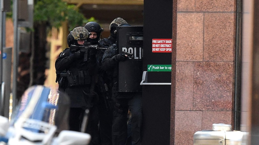 Police with weapons raised on Phillip Street, Sydney