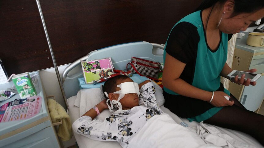 Boy lies in China hospital after attack