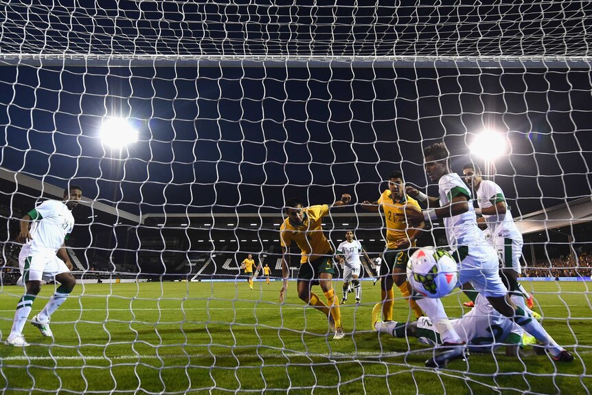 Tim Cahill of Australia scores a goal against Saudi Arabia at Craven Cottage.