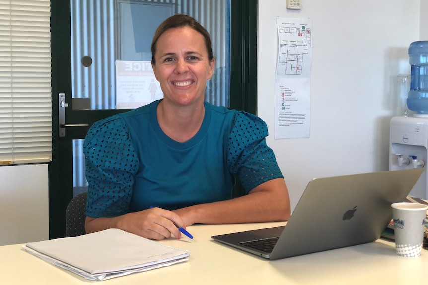 Clare Smith sitting at a desk in front of a computer in an office. 