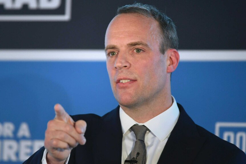 Former Brexit Secretary Dominic Raab wears a suit and points his finger