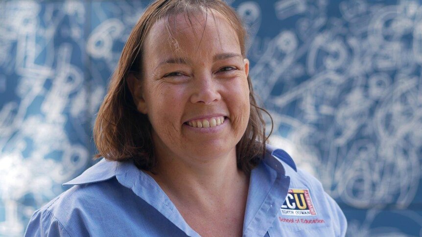 A head and shoulders shot of a smiling Pauline Roberts wearing a blue Edith Cowan University shirt.