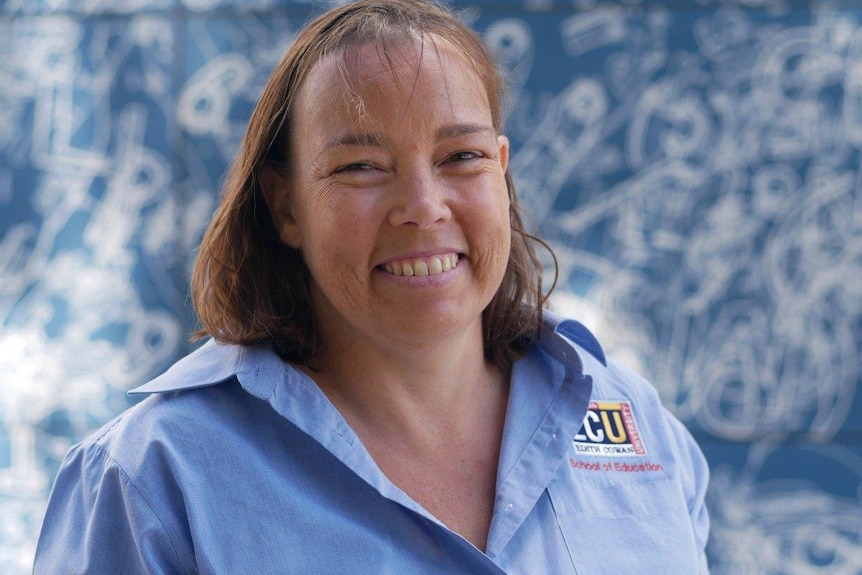 A head and shoulders shot of a smiling Pauline Roberts wearing a blue Edith Cowan University shirt.