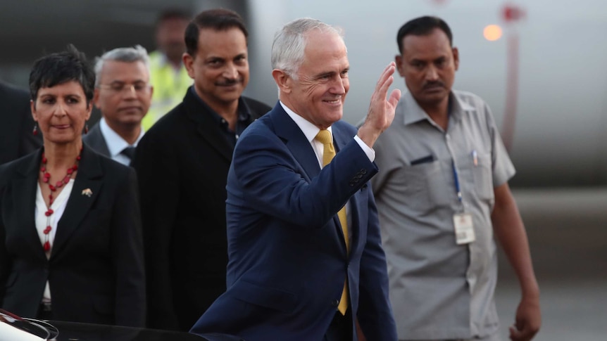 PM Malcolm Turnbull waves as he steps off the aircraft in India