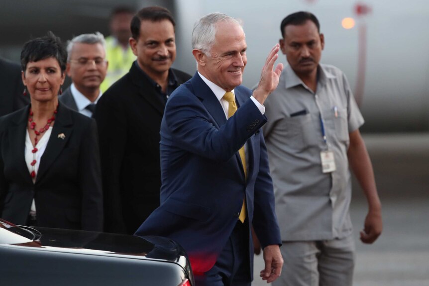 PM Malcolm Turnbull waves as he steps off the aircraft in India