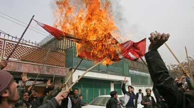 Afghan protesters burn a Danish flag in Kabul