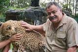 A zoo owner with a cheetah.