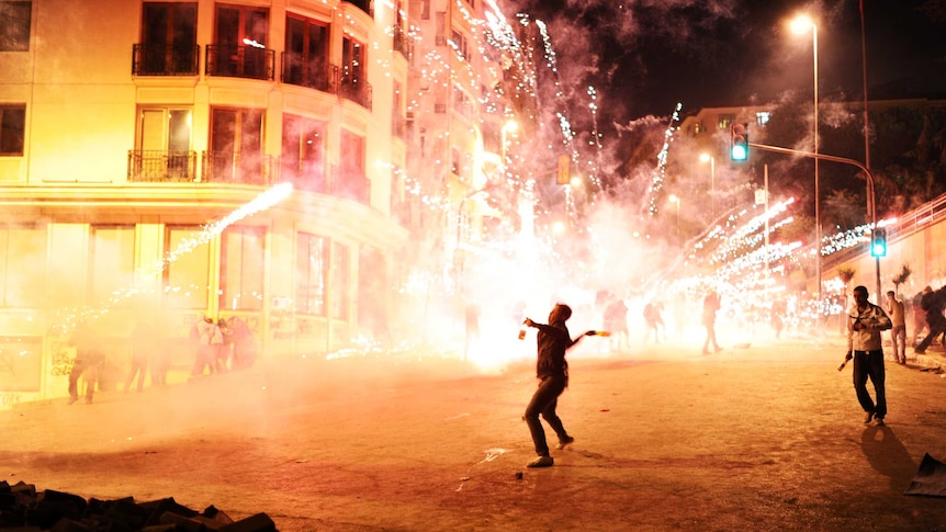 Protestors clash with Turkish riot police.