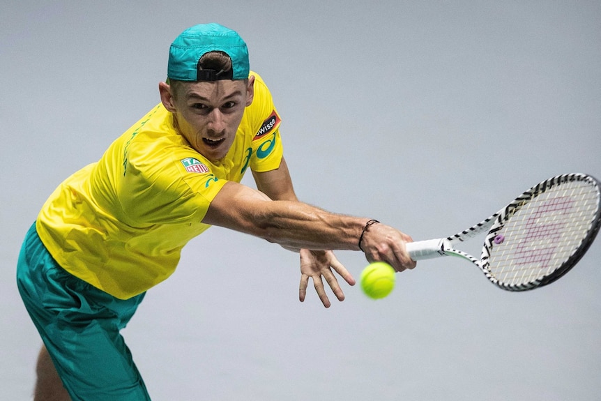 An Australian tennis player reaches for a backhand return at the Davis Cup.