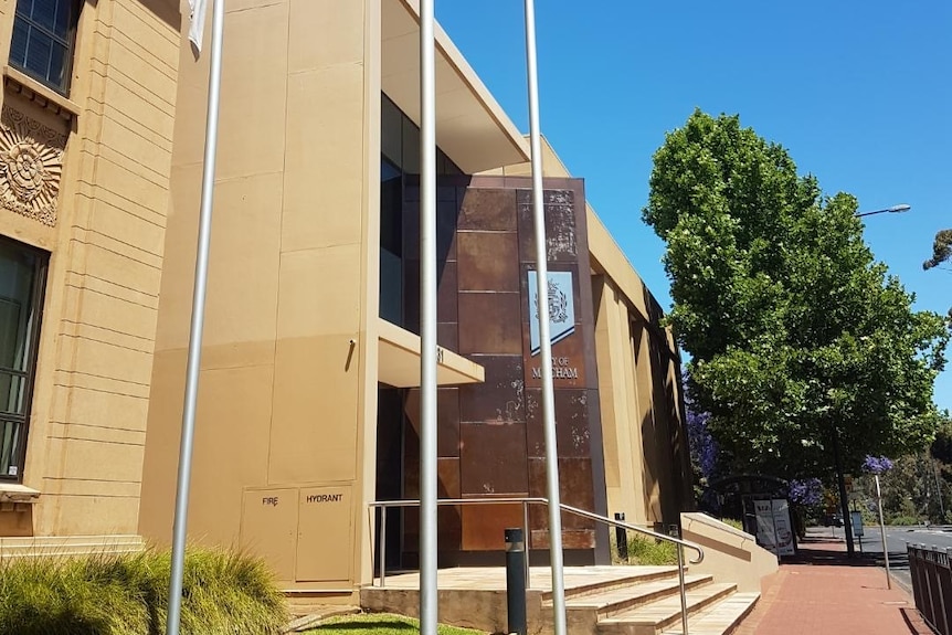 An office building with flags in front