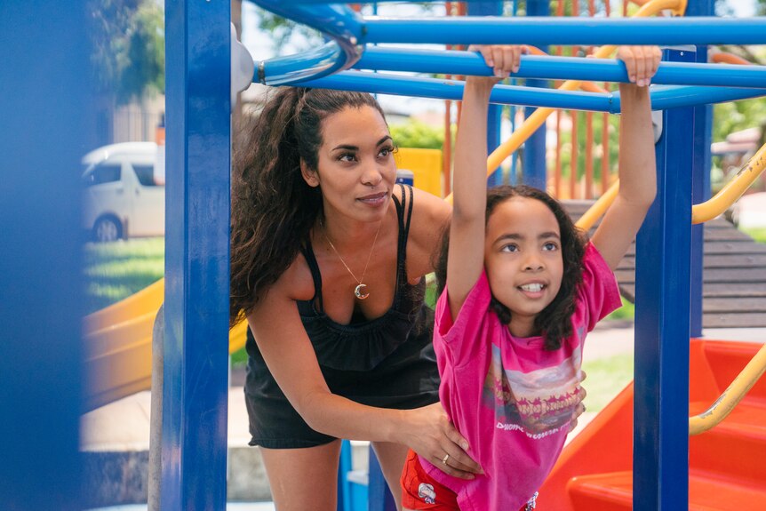 Former charity founder Siham Benz with her child on a playground.