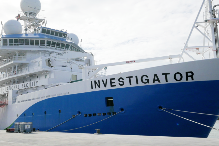 A ship named Investigator docked at a wharf.