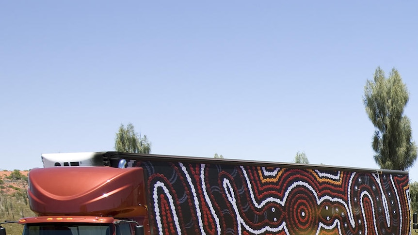 Trucks covered in Indigenous paintings near Uluru.