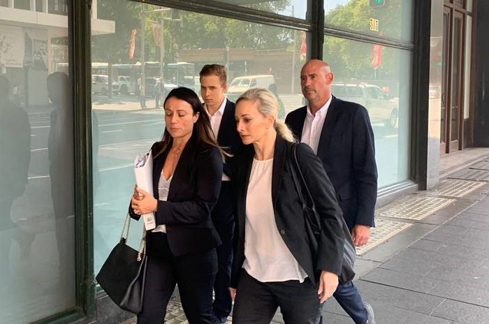 A group of four people leave court