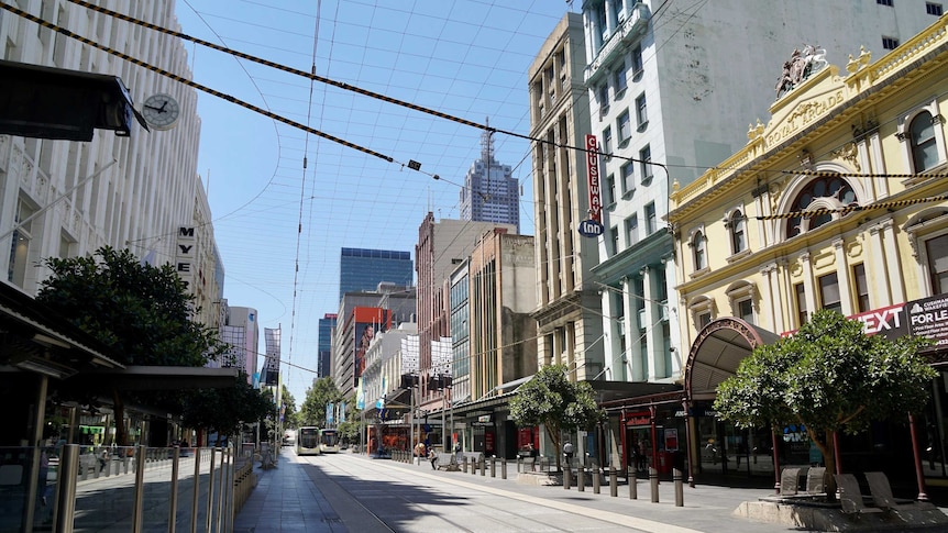 An empty Melbourne CBD street on a blue-sky day.