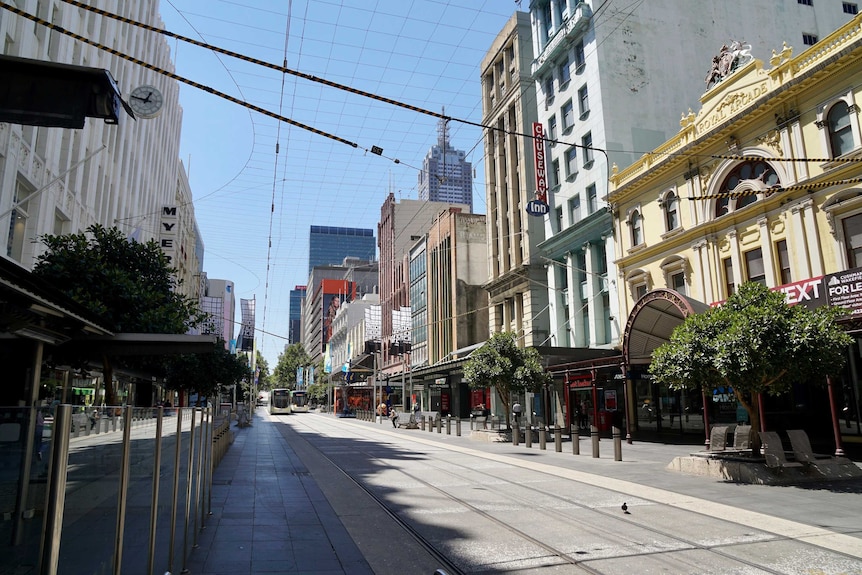 An empty Melbourne CBD street on a blue-sky day.