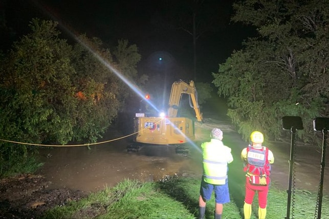 An excavator in deep flood water