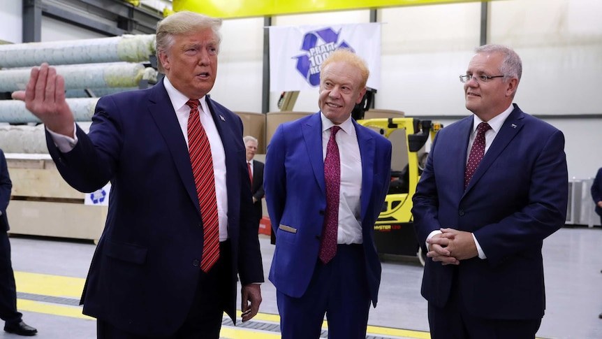 Donald Trump speaks while Scott Morrison and Anthony Pratt watch him