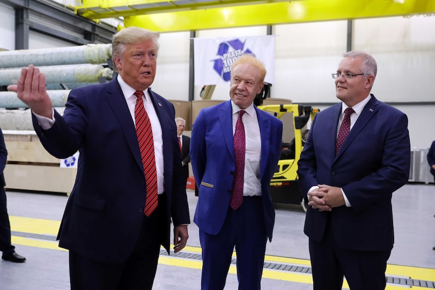 Donald Trump speaks while Scott Morrison and Anthony Pratt watch him