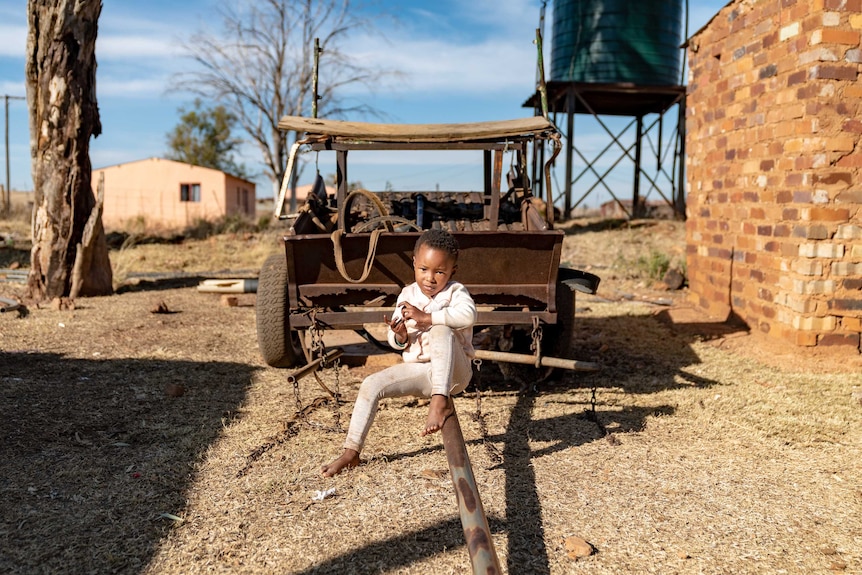 Some farmland has been restored to its previous owners. This girl's family farms at Klipgat, near Potchefstroom.