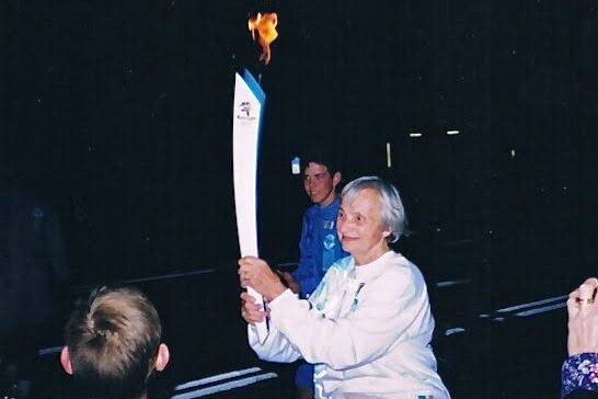 A woman holding Olympic torch.