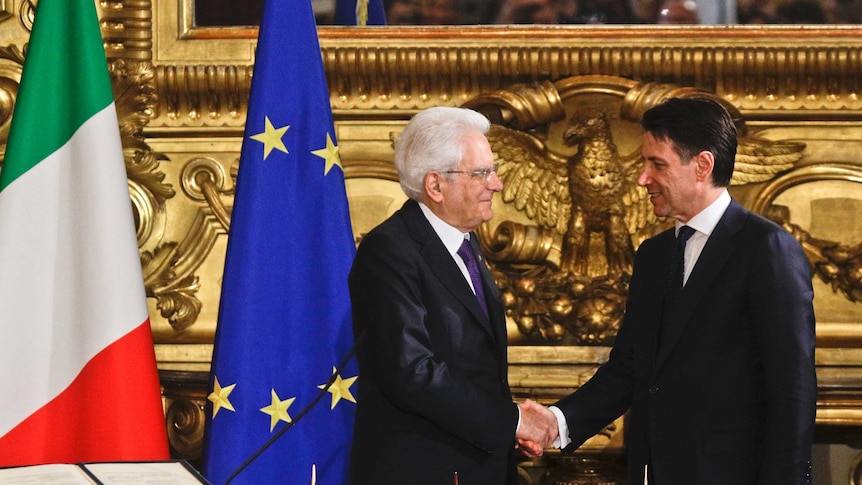 Italian President Sergio Mattarella, left, shakes hands with Prime Minister Giuseppe Conte during the swearing-in ceremony.