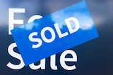 A sold sticker on a real estate for sale sign.