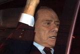 End of an era: Silvio Berlusconi leaves parliament after the vote.