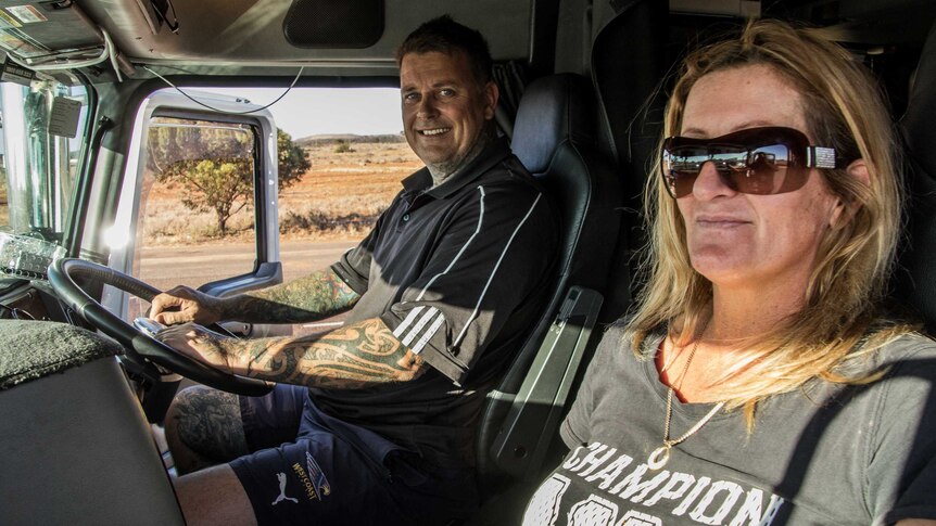 Truck driver and passenger in cab of prime mover