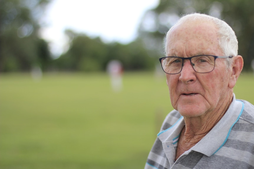 Portrait of elderly man watching cricket match