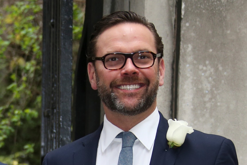 A photo of James Murdoch wearing glasses and smiling into the camera.
