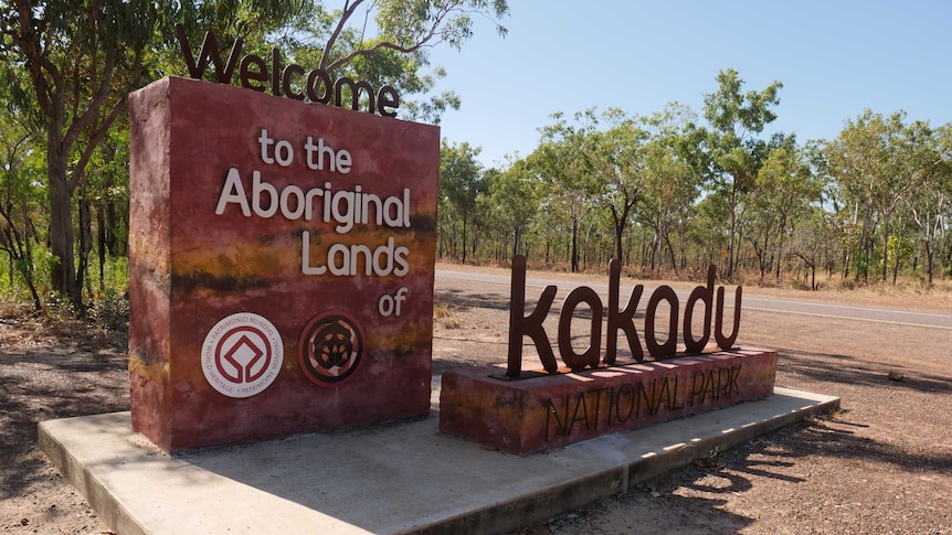 A sign reading 'Welcome to the Aboriginal Lands of Kakadu National Park' at the start of the park.