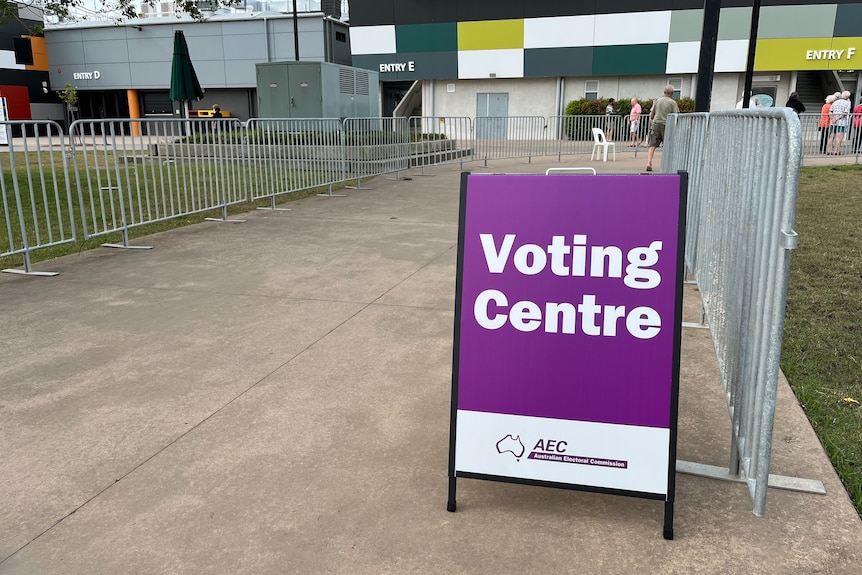 A purple voting centre sign. 