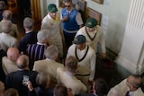 A screenshot showing Australian cricketers walking through the Lord's Long Room, with Usman Khawaja talking to a member.