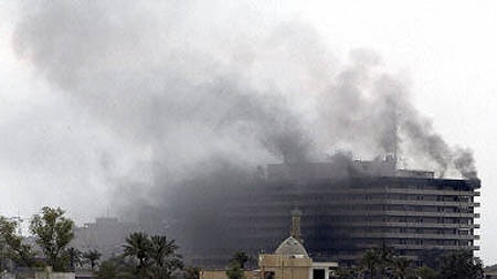 Smoke billows from the Iraqi information ministry after looters had set it alight in Baghdad