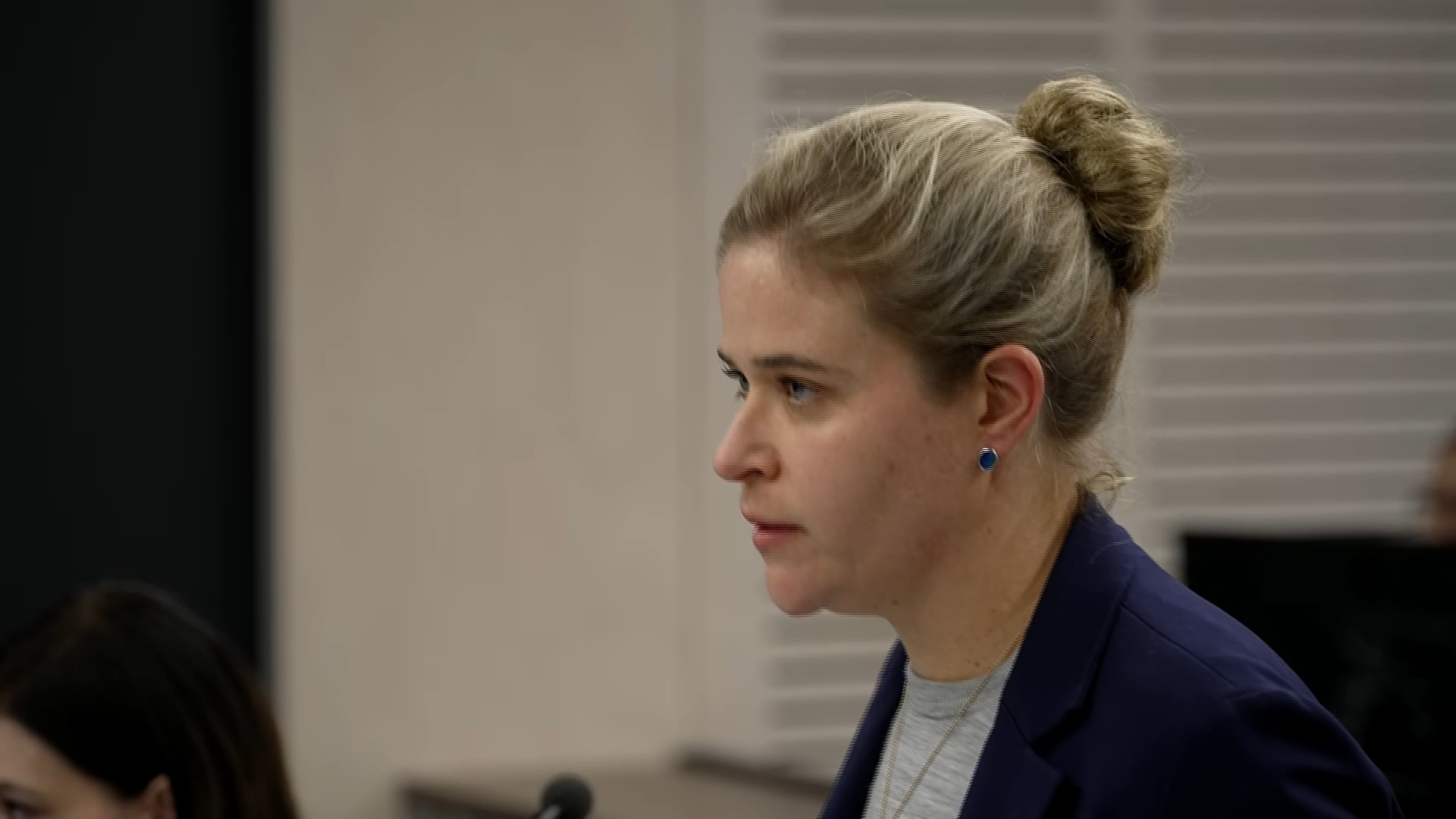 Woman standing in a room speaking