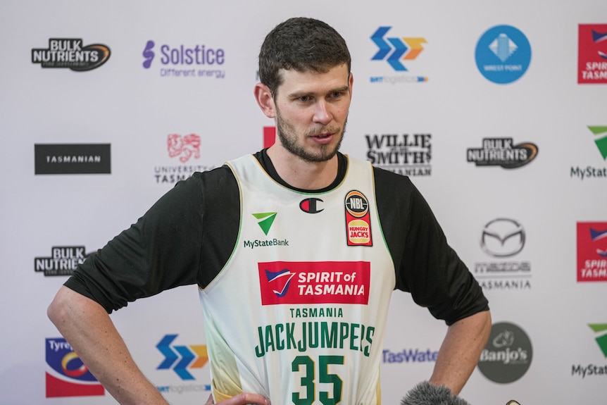 A basketball player speaking to media off camera.