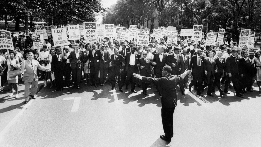 Martin Luther King Jr. walks with supporters during the March on Washington