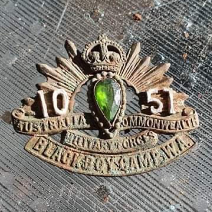 A war badge with a green stone.