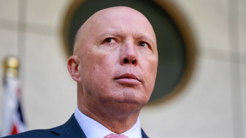 Peter Dutton, framed by a round window.