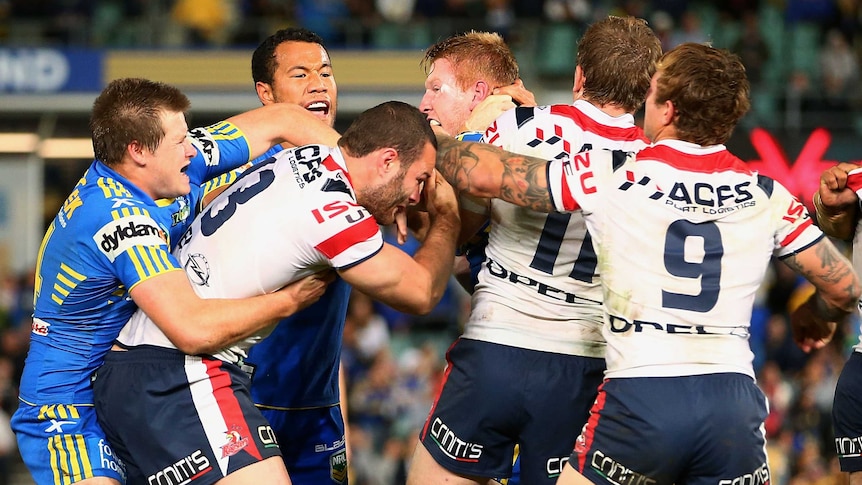 Boyd Cordner (13) of the Roosters and Matt Ryan of the Eels fight during the round 13 NRL match
