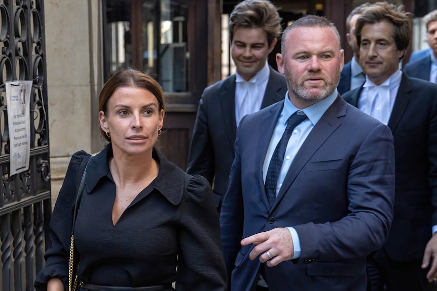 A famous husband and wife leave a courtroom